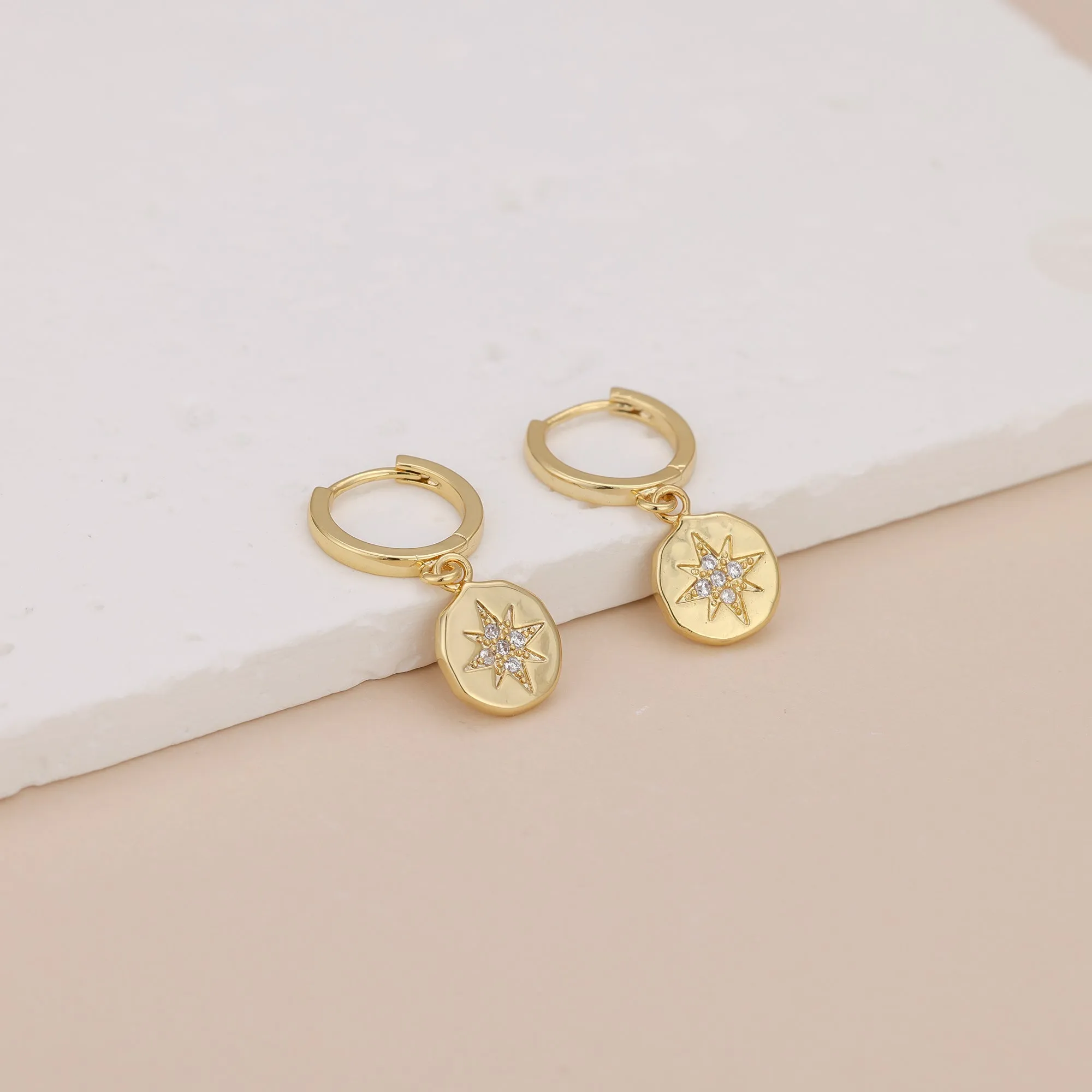 E056 gold starburst dangle earrings